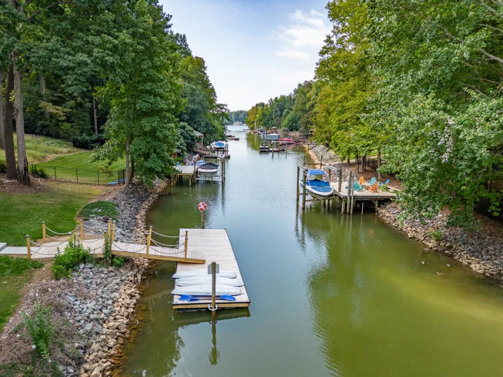 An aerial perspective of the private dock, showing the surrounding waterway and nearby boats nestled along the shore.