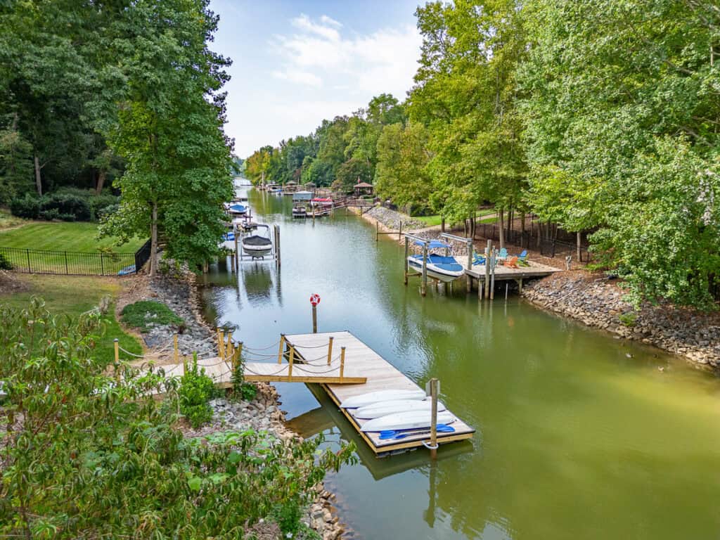a dock on a river with boats and trees