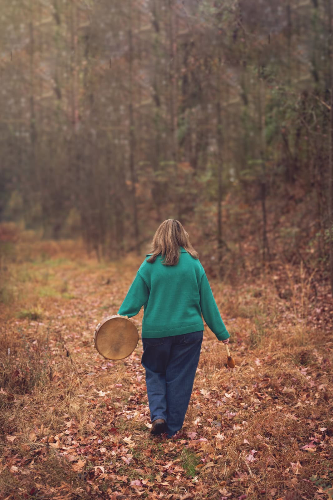 a woman walking in the woods
