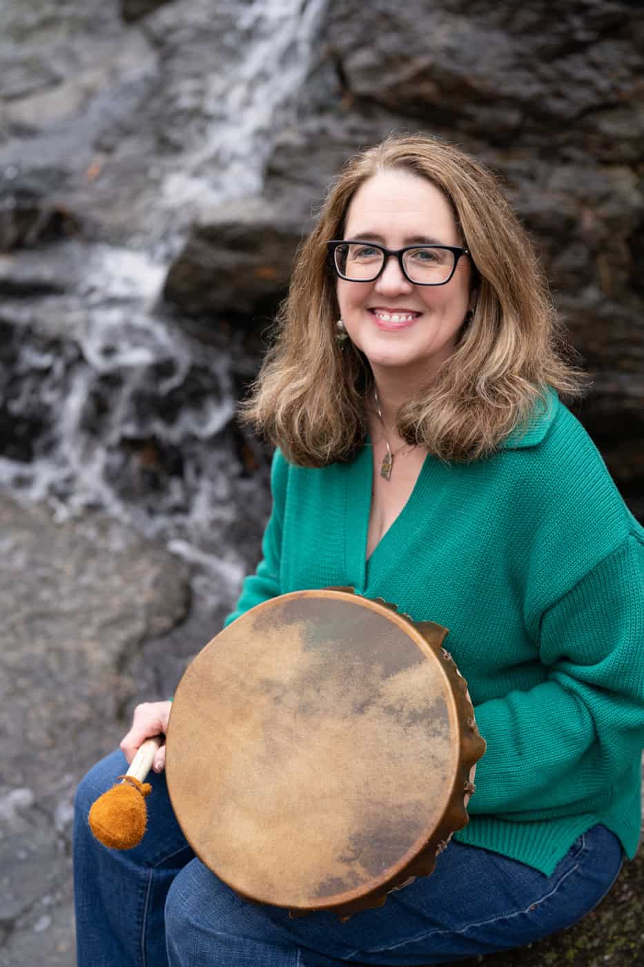 a woman holding a drum