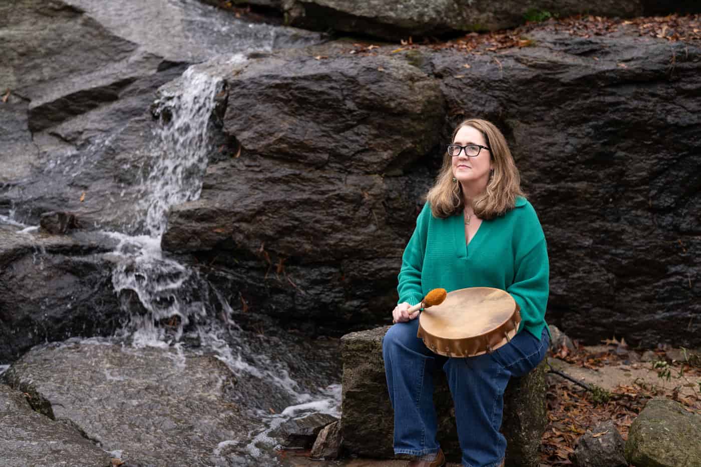 a woman holding a drum