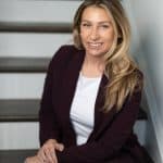 a woman sitting on stairs smiling