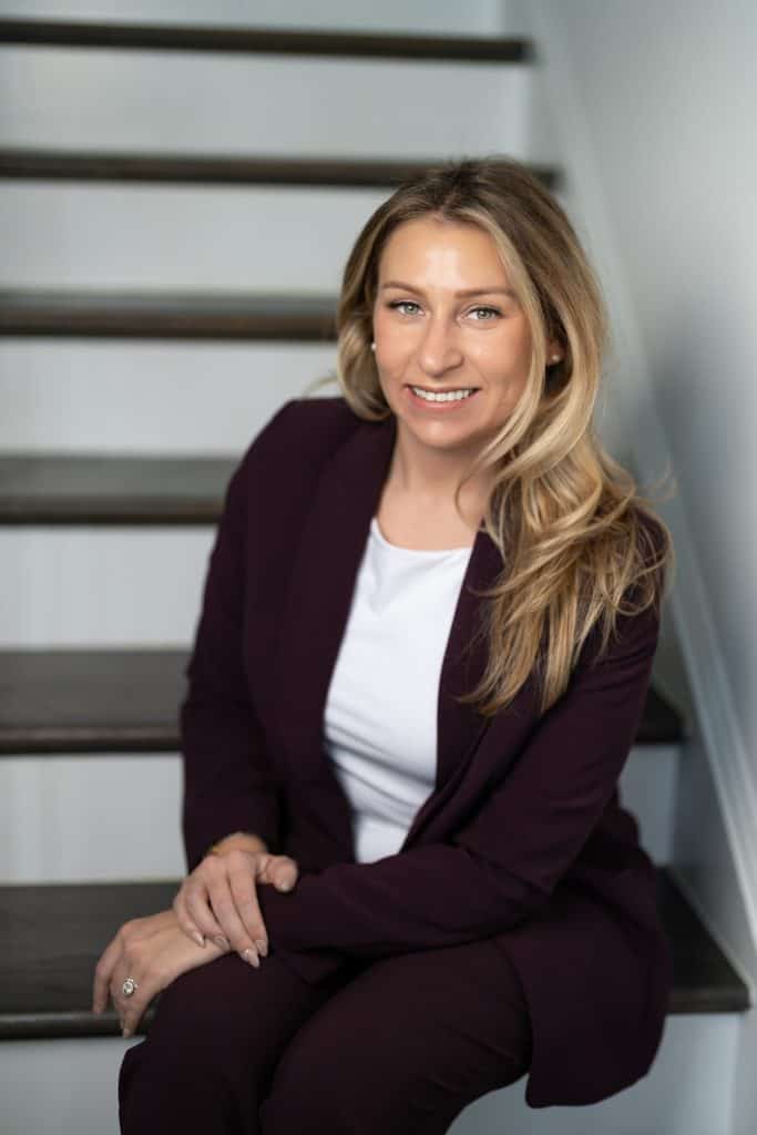 a woman sitting on stairs smiling
