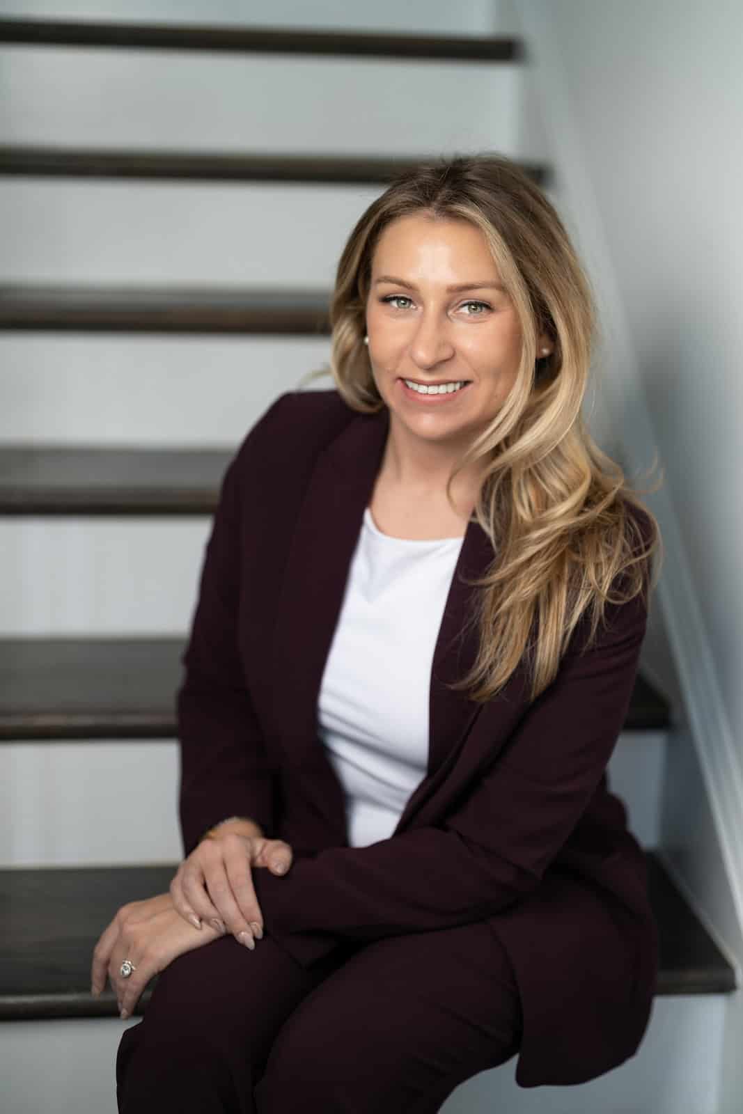a woman sitting on stairs smiling