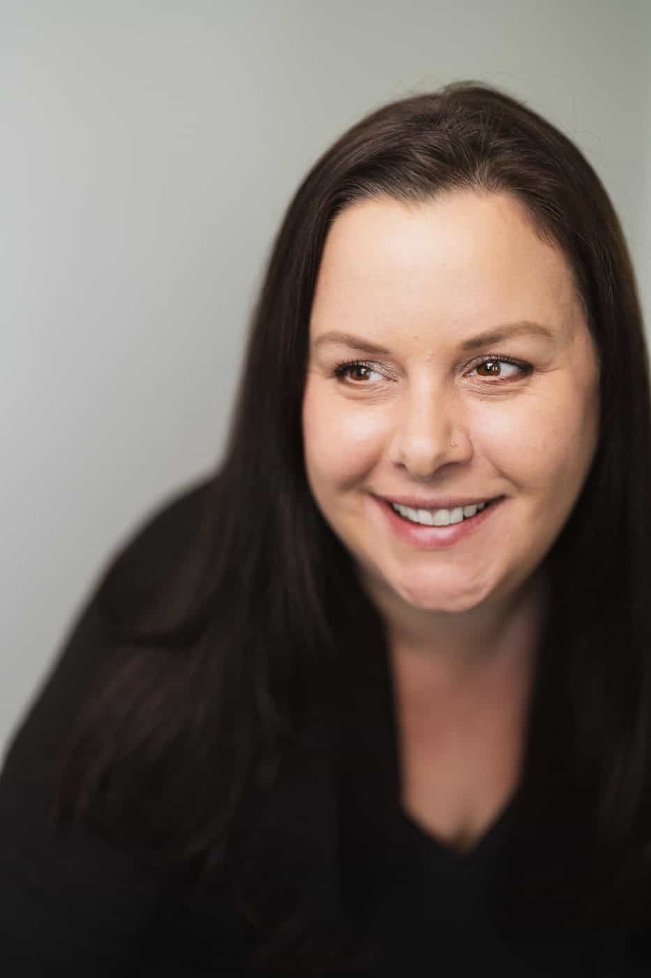 a woman with long brown hair smiling