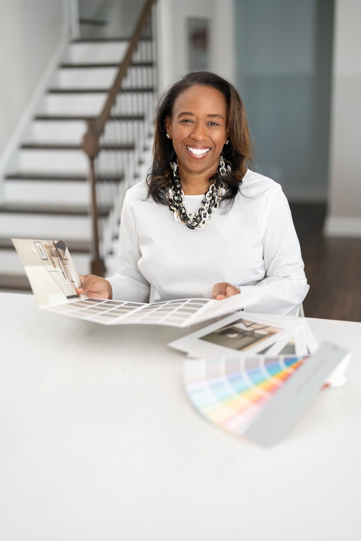 a woman holding a color swatch