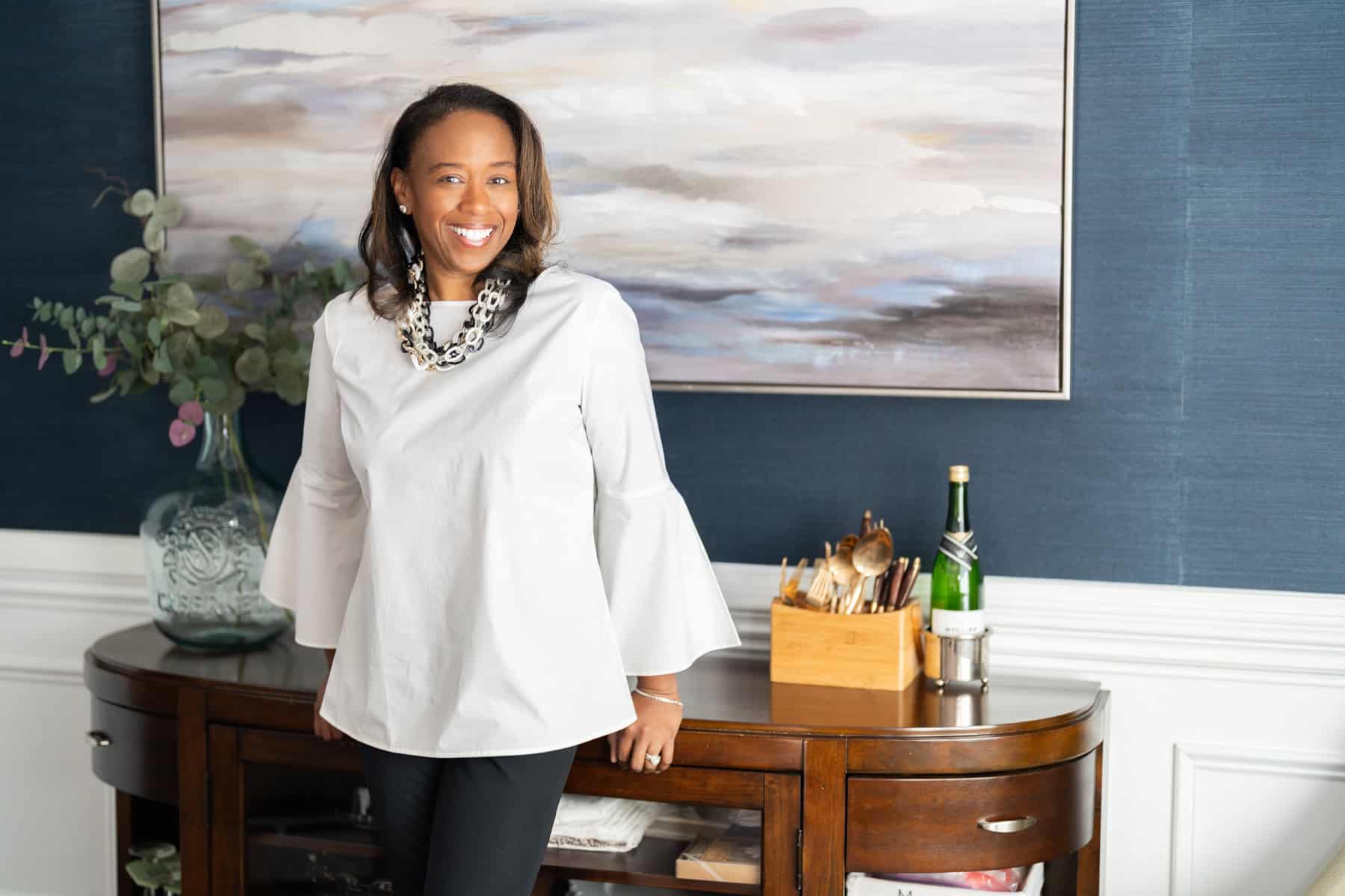 a woman standing next to a table