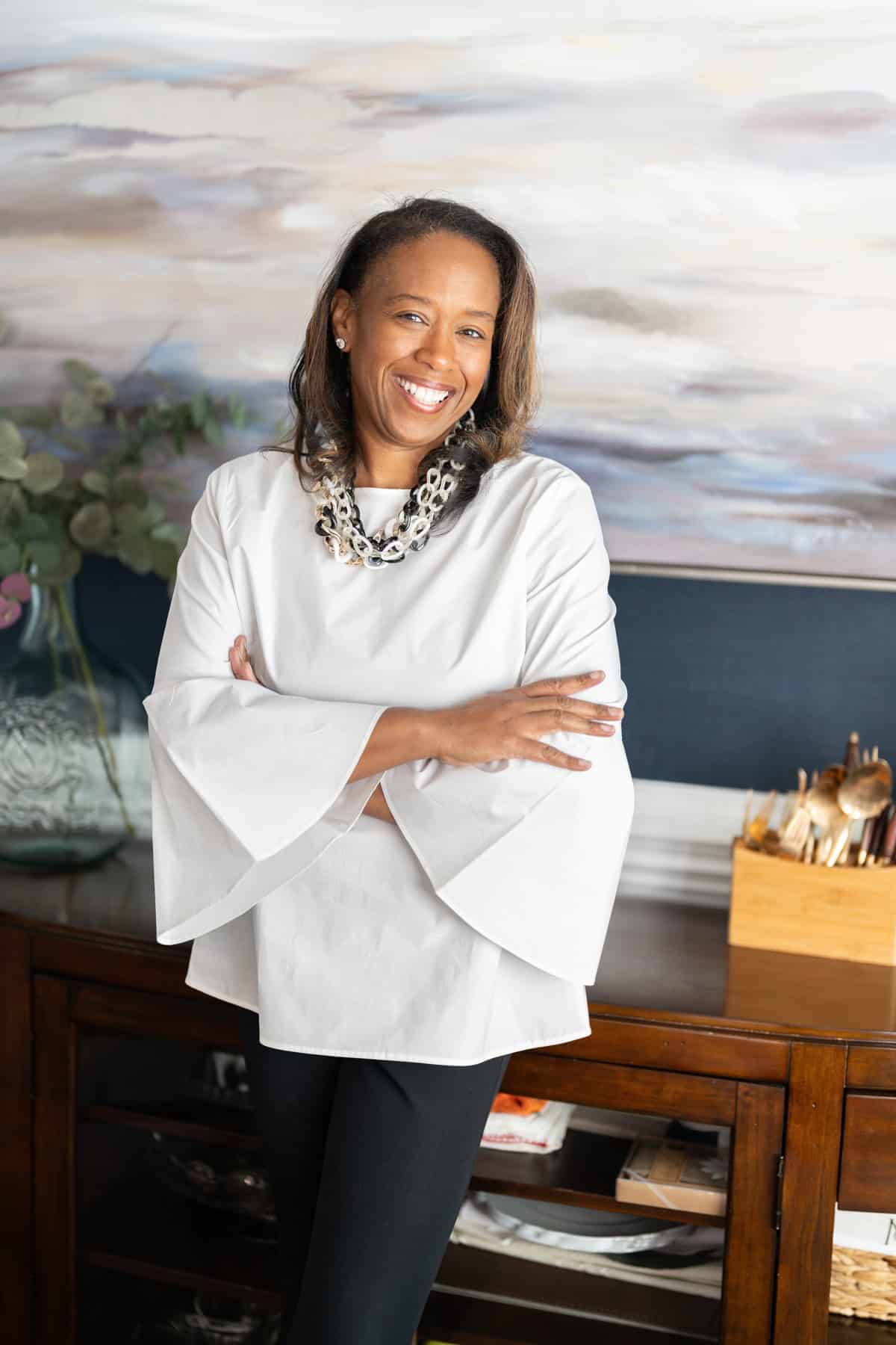 a woman smiling with her arms crossed