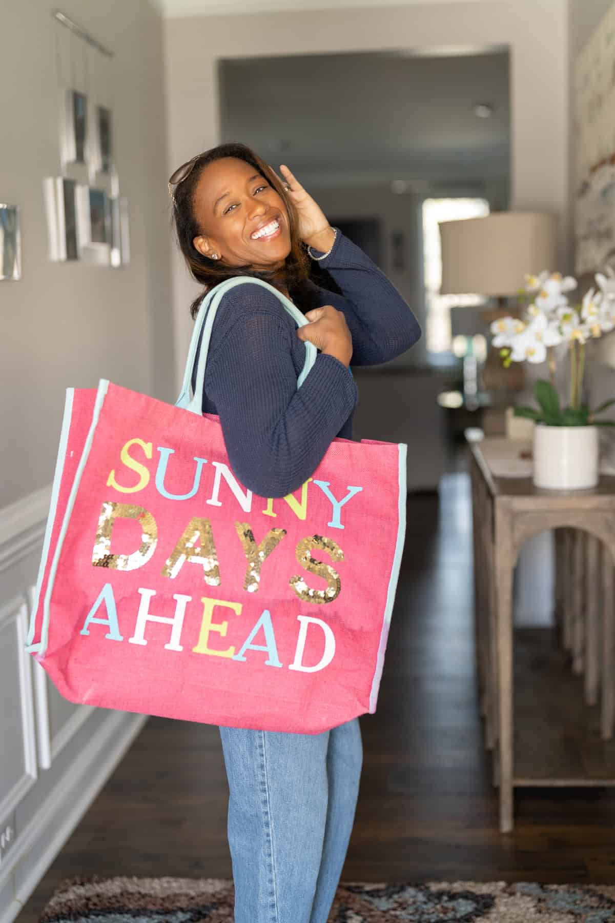a woman holding a pink bag