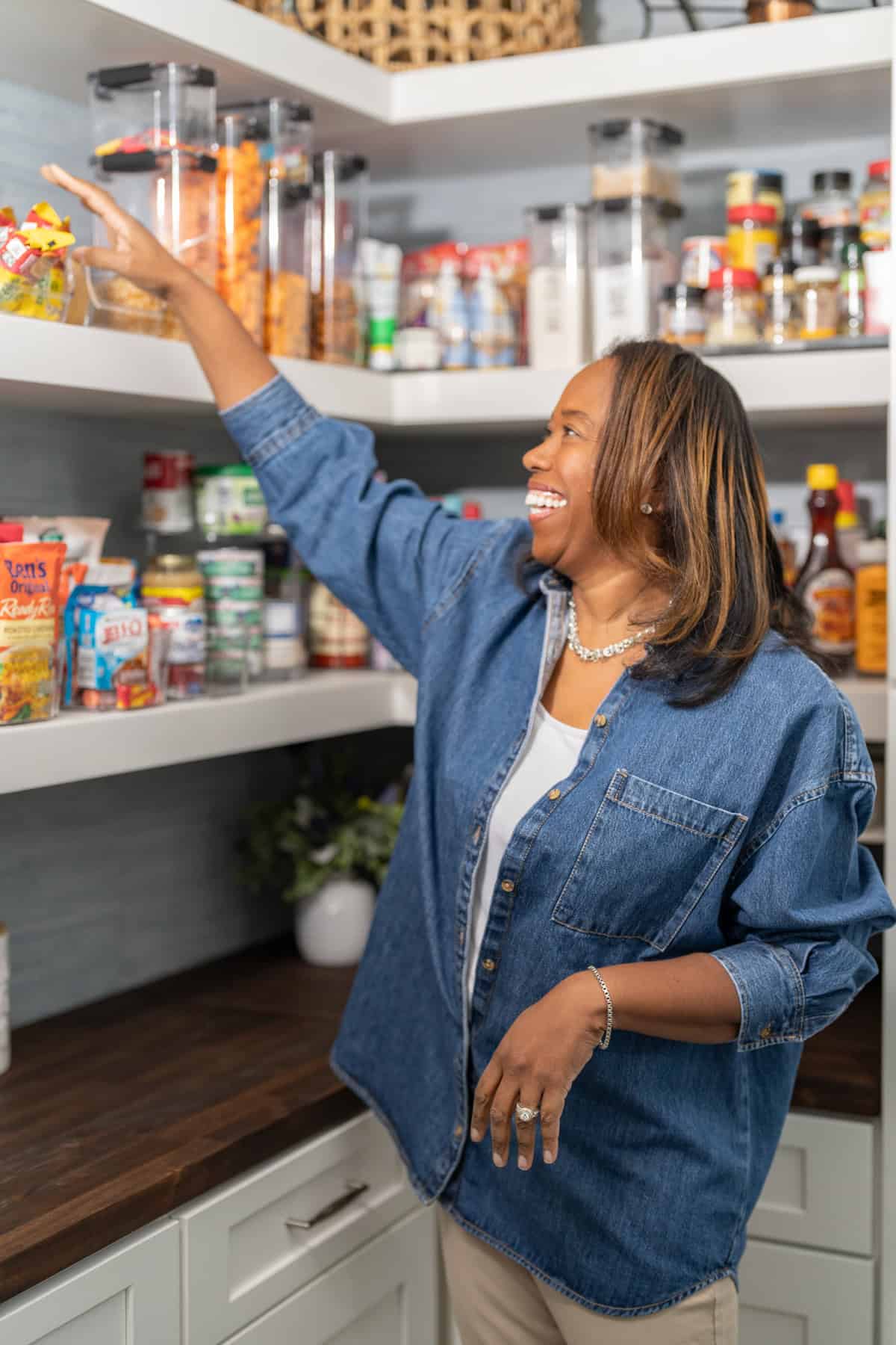 a woman reaching out a glass container of food