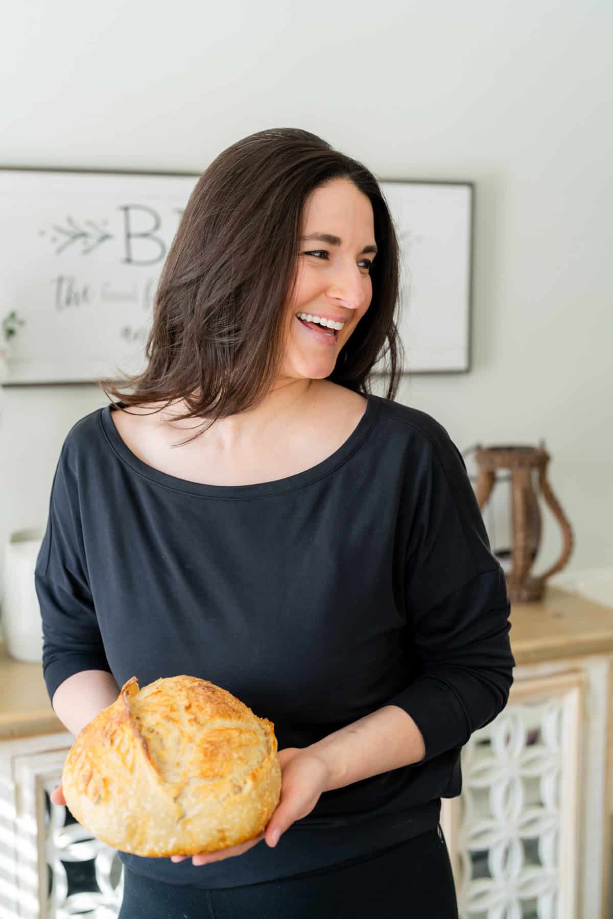 a woman holding a loaf of bread